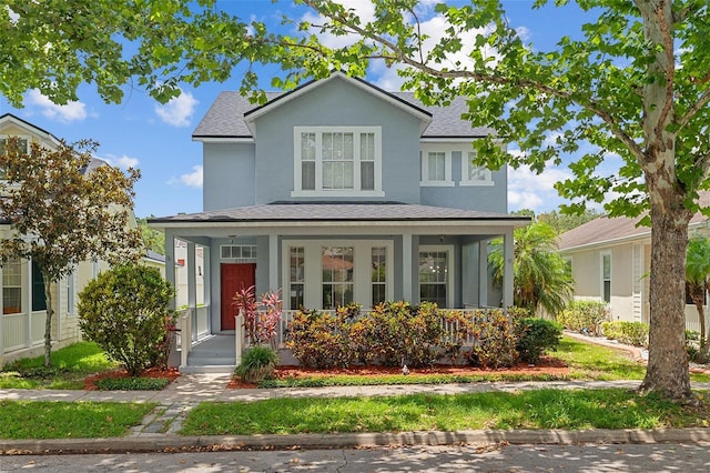 6905 Beargrass Rd, Harmony, FL 34773 - view of front of home featuring a porch, roof with shingles, and stucco siding