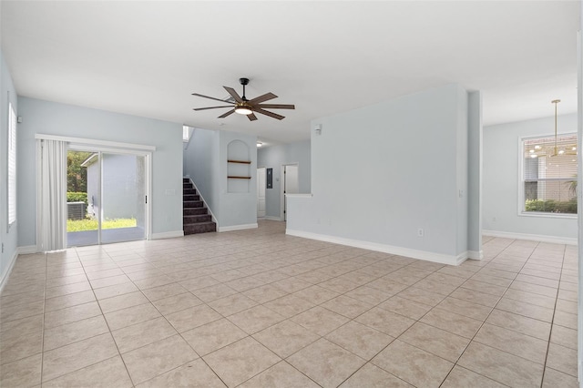 6905 Beargrass Rd, Harmony, FL 34773 - unfurnished living room with light tile patterned floors, a ceiling fan, and stairs