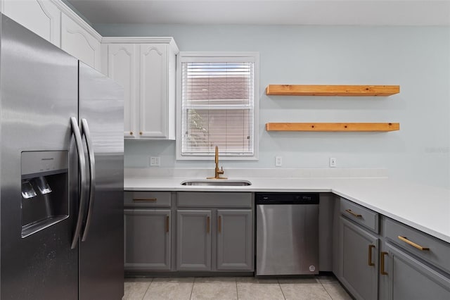 6905 Beargrass Rd, Harmony, FL 34773 - kitchen featuring appliances with stainless steel finishes, gray cabinets, and light tile patterned floors