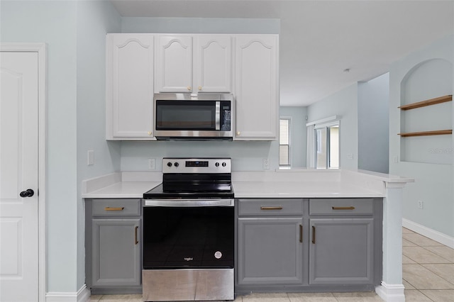 6905 Beargrass Rd, Harmony, FL 34773 - kitchen featuring appliances with stainless steel finishes, gray cabinetry, light countertops, and light tile patterned floors