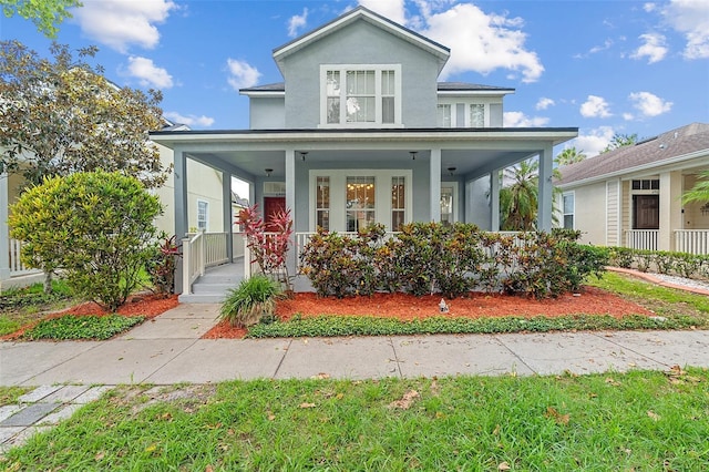 6905 Beargrass Rd, Harmony, FL 34773 - view of front facade with covered porch and stucco siding