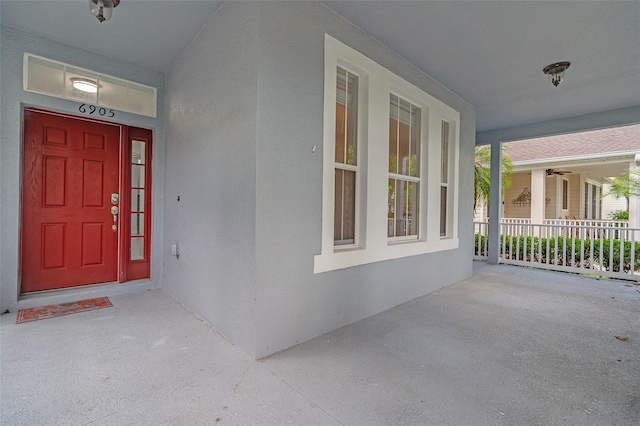 6905 Beargrass Rd, Harmony, FL 34773 - entrance to property with a porch and stucco siding