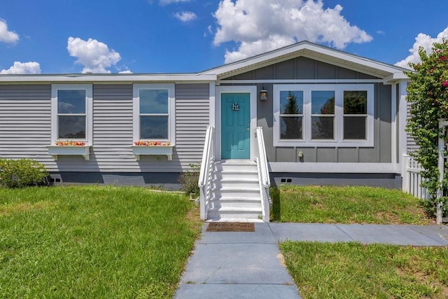 4361 Albritton Rd, Saint Cloud, FL 34772 - view of front facade featuring board and batten siding, crawl space, and a front lawn