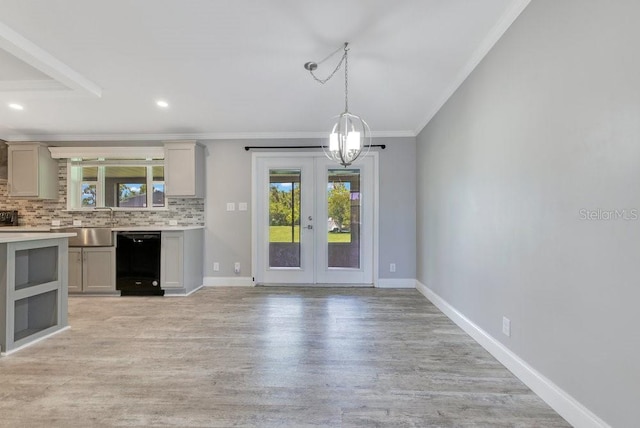 4361 Albritton Rd, Saint Cloud, FL 34772 - kitchen featuring black dishwasher, ornamental molding, healthy amount of natural light, light wood finished floors, and light countertops