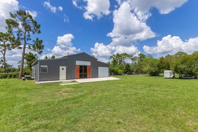 4361 Albritton Rd, Saint Cloud, FL 34772 - rear view of property with a detached garage, an outdoor structure, and a yard