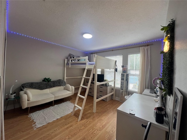 3339 Primrose Willow Dr, Saint Cloud, FL 34773 - bedroom featuring a textured ceiling and light wood finished floors