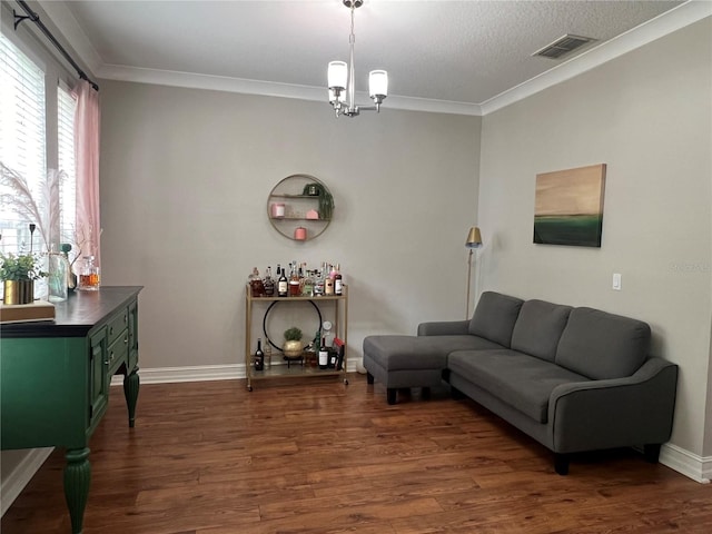 3339 Primrose Willow Dr, Saint Cloud, FL 34773 - living room featuring dark wood-style floors, crown molding, and a chandelier