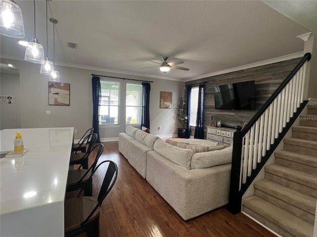 3339 Primrose Willow Dr, Saint Cloud, FL 34773 - living room featuring a ceiling fan, stairway, ornamental molding, and dark wood-style flooring