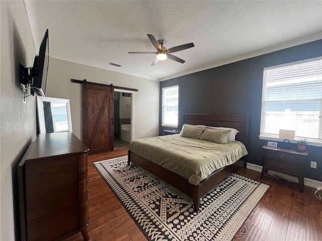 3339 Primrose Willow Dr, Saint Cloud, FL 34773 - bedroom with a barn door, a textured ceiling, wood finished floors, crown molding, and a ceiling fan