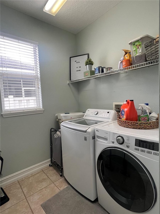 3339 Primrose Willow Dr, Saint Cloud, FL 34773 - laundry area featuring washer and dryer, light tile patterned floors, and a textured ceiling