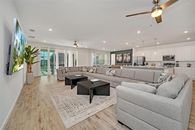 2525 Shanti Dr, Kissimmee, FL 34746 - living area featuring a ceiling fan, recessed lighting, and light wood-type flooring