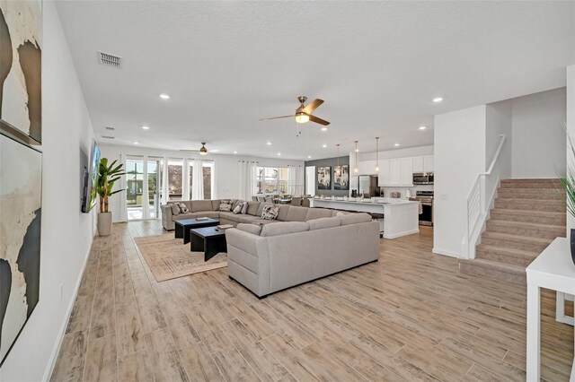 2525 Shanti Dr, Kissimmee, FL 34746 - living area featuring a ceiling fan, stairway, light wood-style flooring, and recessed lighting