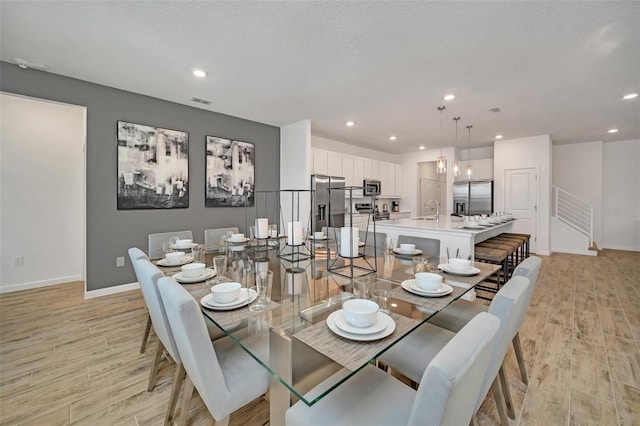 2525 Shanti Dr, Kissimmee, FL 34746 - dining space with light wood-style floors and recessed lighting