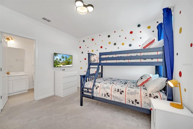 2525 Shanti Dr, Kissimmee, FL 34746 - bedroom featuring light colored carpet and connected bathroom