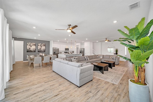 2525 Shanti Dr, Kissimmee, FL 34746 - living area featuring a ceiling fan, light wood-style floors, and recessed lighting