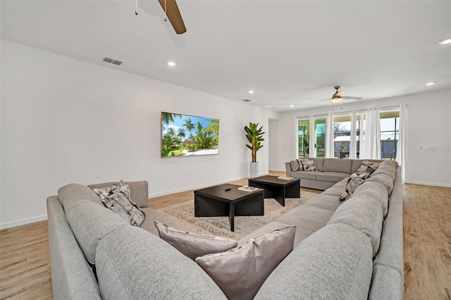 2525 Shanti Dr, Kissimmee, FL 34746 - living room with ceiling fan, recessed lighting, and light wood-style floors