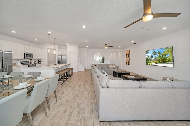 2525 Shanti Dr, Kissimmee, FL 34746 - living room featuring ceiling fan, light wood-style flooring, and recessed lighting