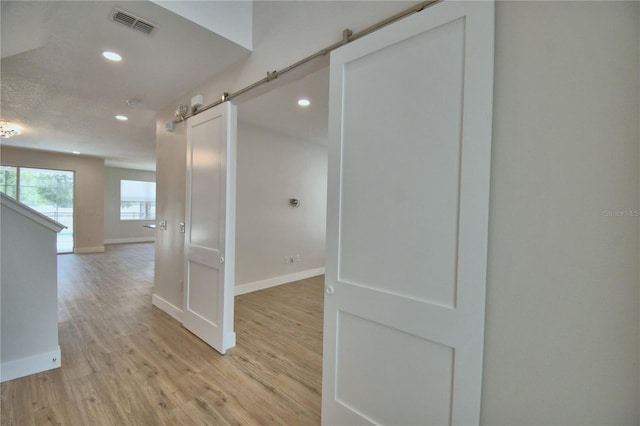 2673 Calistoga Ave, Kissimmee, FL 34741 - corridor with a barn door, recessed lighting, and light wood finished floors