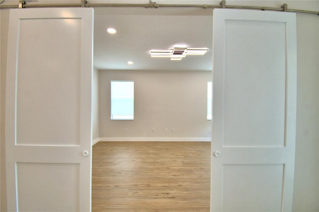 2673 Calistoga Ave, Kissimmee, FL 34741 - empty room featuring recessed lighting, wood finished floors, and a barn door