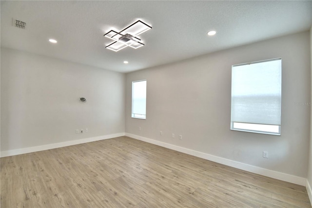 2673 Calistoga Ave, Kissimmee, FL 34741 - unfurnished room with wood finished floors and recessed lighting