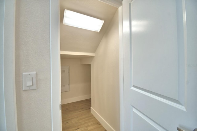 2673 Calistoga Ave, Kissimmee, FL 34741 - hallway with light wood finished floors, a textured wall, and a skylight