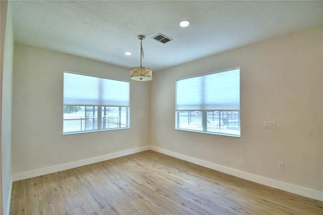 2673 Calistoga Ave, Kissimmee, FL 34741 - unfurnished room featuring wood finished floors, recessed lighting, and a textured ceiling