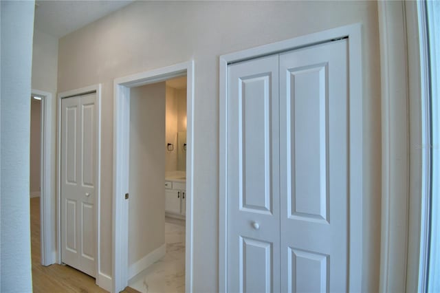 2673 Calistoga Ave, Kissimmee, FL 34741 - hallway featuring light marble finish flooring and baseboards