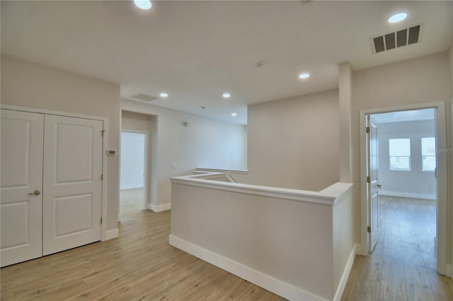 2673 Calistoga Ave, Kissimmee, FL 34741 - corridor with light wood-style flooring, recessed lighting, and an upstairs landing
