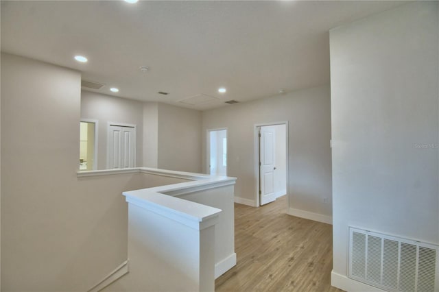 2673 Calistoga Ave, Kissimmee, FL 34741 - corridor featuring light wood finished floors, recessed lighting, and an upstairs landing