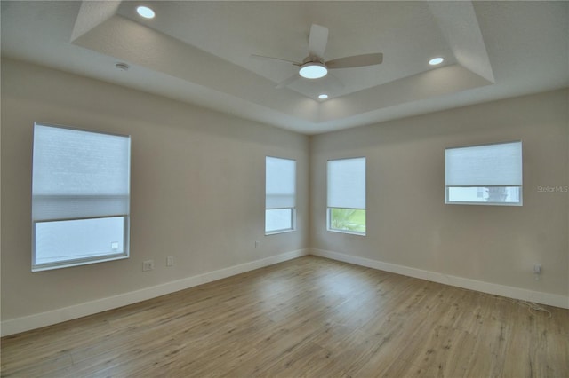 2673 Calistoga Ave, Kissimmee, FL 34741 - empty room featuring a raised ceiling, light wood finished floors, recessed lighting, and a ceiling fan