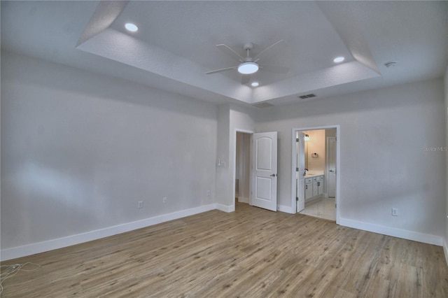 2673 Calistoga Ave, Kissimmee, FL 34741 - unfurnished room featuring a tray ceiling, a ceiling fan, light wood-style floors, and recessed lighting