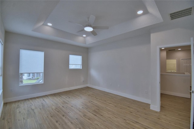 2673 Calistoga Ave, Kissimmee, FL 34741 - spare room with a raised ceiling, ceiling fan, wood finished floors, and recessed lighting