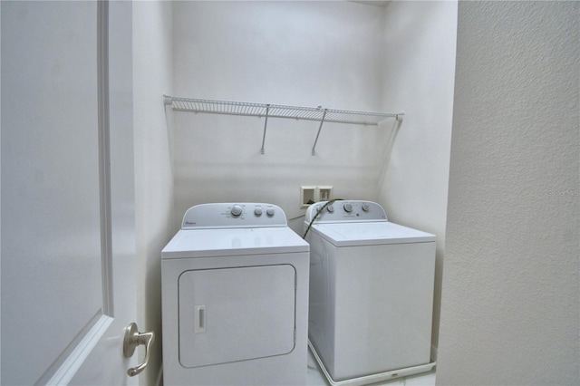 2673 Calistoga Ave, Kissimmee, FL 34741 - laundry room with washer and dryer and a textured wall