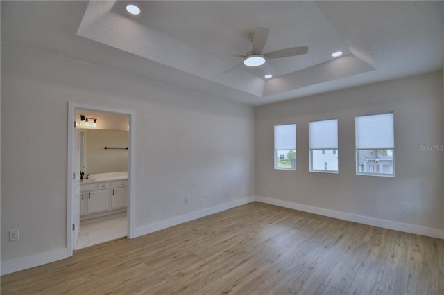 2673 Calistoga Ave, Kissimmee, FL 34741 - unfurnished room with a tray ceiling, a ceiling fan, light wood finished floors, and recessed lighting