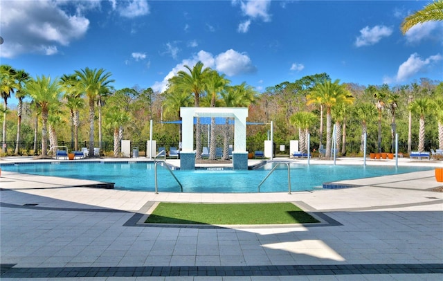2673 Calistoga Ave, Kissimmee, FL 34741 - community pool with a patio area and view of scattered trees