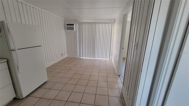 10301 US Highway 27 Unit 94B, Clermont, FL 34711 - empty room featuring light tile patterned flooring, washer / dryer, and a wall mounted air conditioner