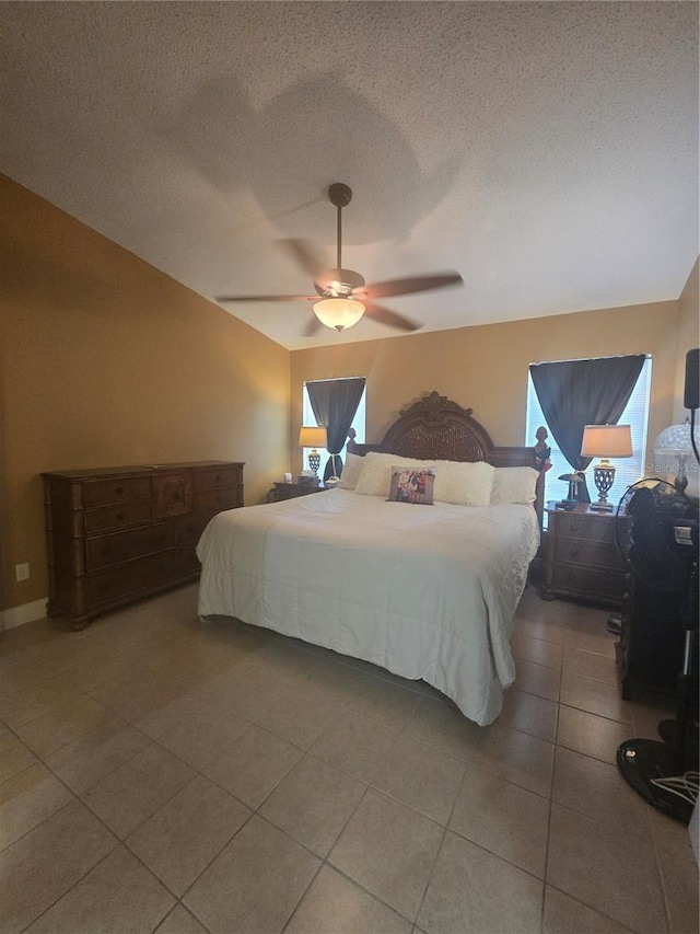 204 Canary Island Cir, Davenport, FL 33837 - bedroom with vaulted ceiling, tile patterned floors, a textured ceiling, and ceiling fan