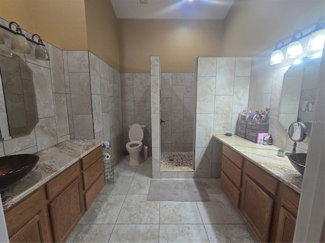 204 Canary Island Cir, Davenport, FL 33837 - bathroom featuring tile walls, a walk in shower, vanity, and tile patterned floors