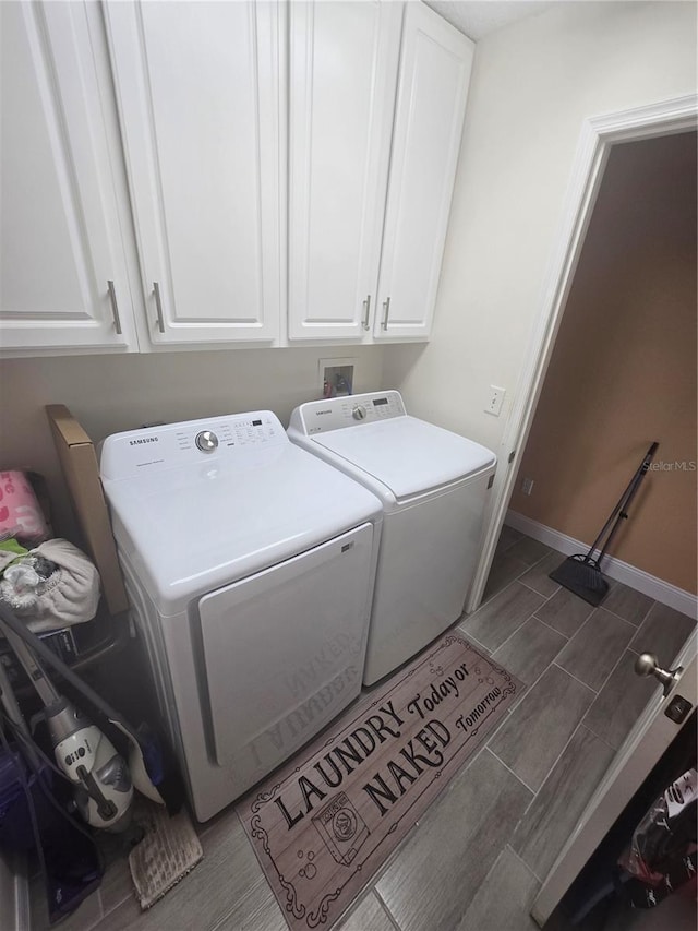 204 Canary Island Cir, Davenport, FL 33837 - laundry room with washing machine and clothes dryer, wood tiled floors, and cabinet space