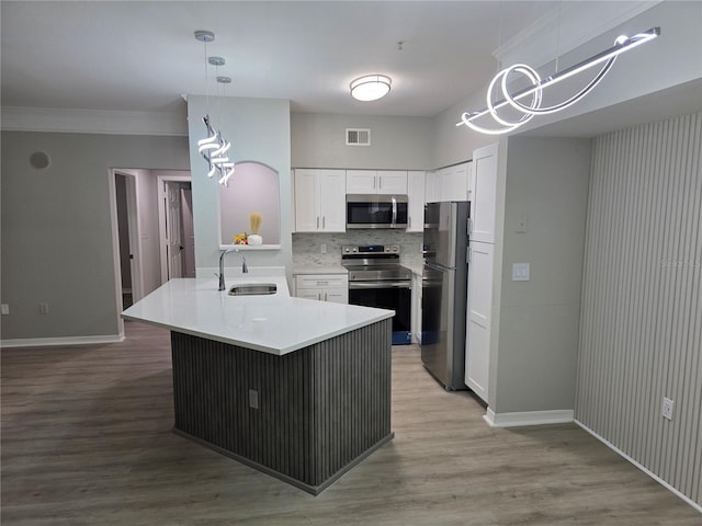 3428 Soho St Unit 208, Orlando, FL 32835 - kitchen with appliances with stainless steel finishes, a peninsula, white cabinetry, light countertops, and light wood-style floors