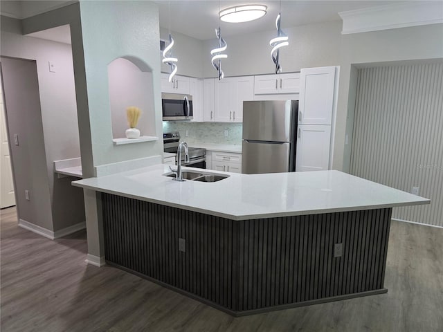 3428 Soho St Unit 208, Orlando, FL 32835 - kitchen featuring stainless steel appliances, wood finished floors, white cabinetry, light countertops, and backsplash