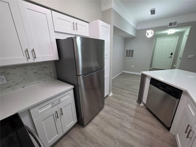 3428 Soho St Unit 208, Orlando, FL 32835 - kitchen with appliances with stainless steel finishes, crown molding, decorative backsplash, white cabinetry, and light wood-type flooring