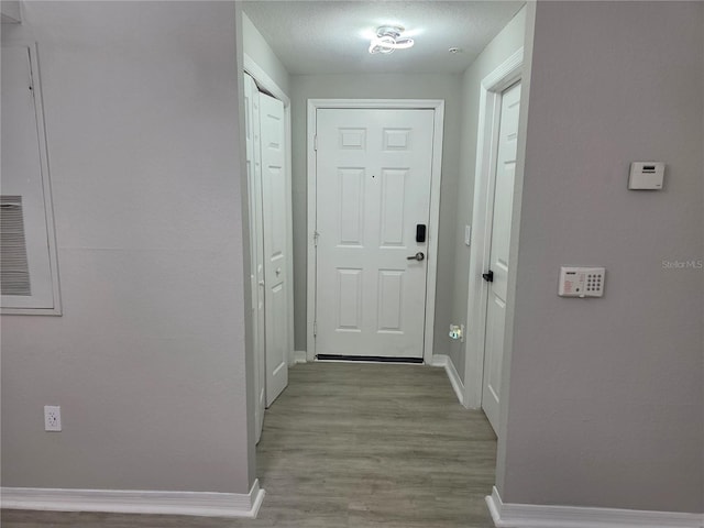 3428 Soho St Unit 208, Orlando, FL 32835 - entryway with baseboards and wood finished floors