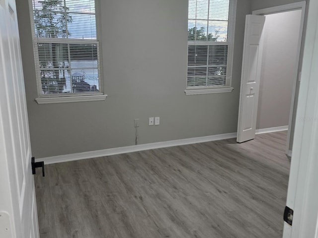3428 Soho St Unit 208, Orlando, FL 32835 - spare room featuring wood finished floors and plenty of natural light
