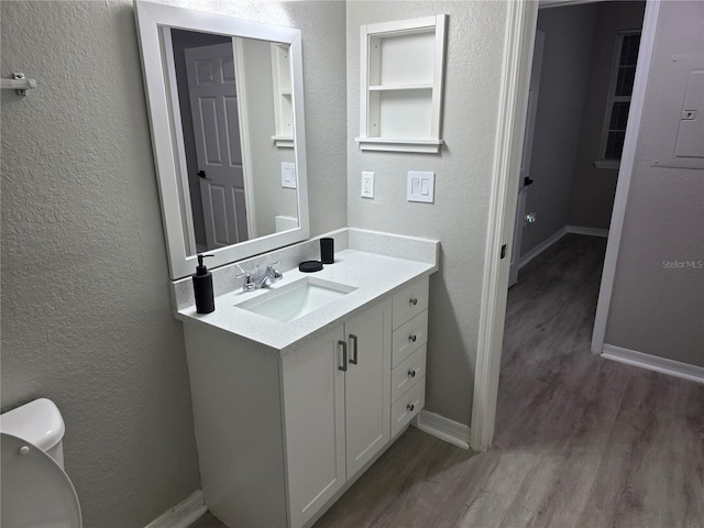 3428 Soho St Unit 208, Orlando, FL 32835 - bathroom with vanity, wood finished floors, and a textured wall