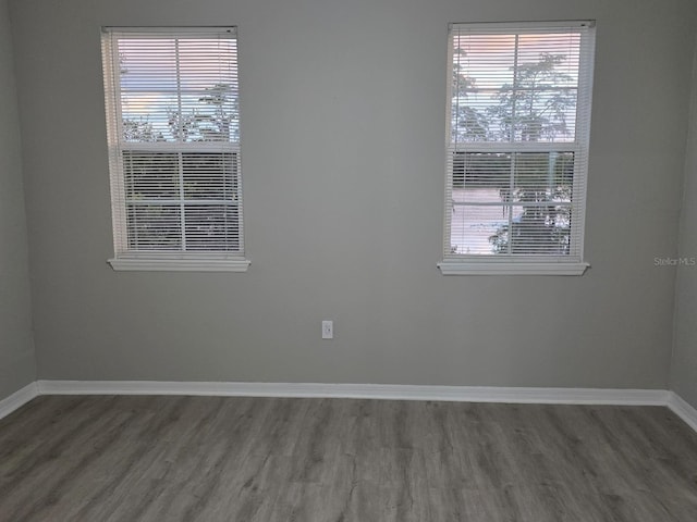3428 Soho St Unit 208, Orlando, FL 32835 - spare room featuring wood finished floors and baseboards