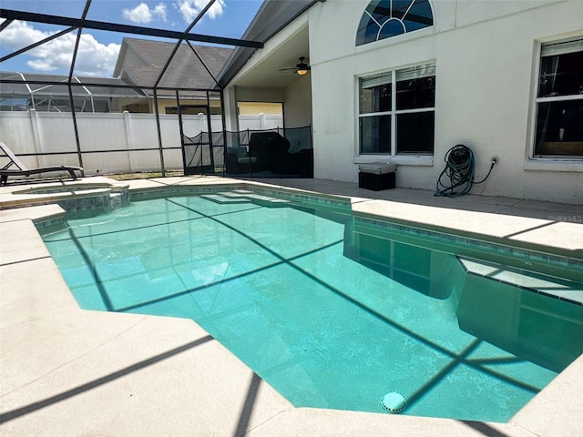 2807 Playing Otter Ct, Kissimmee, FL 34747 - view of swimming pool featuring a patio, a pool with connected hot tub, and glass enclosure