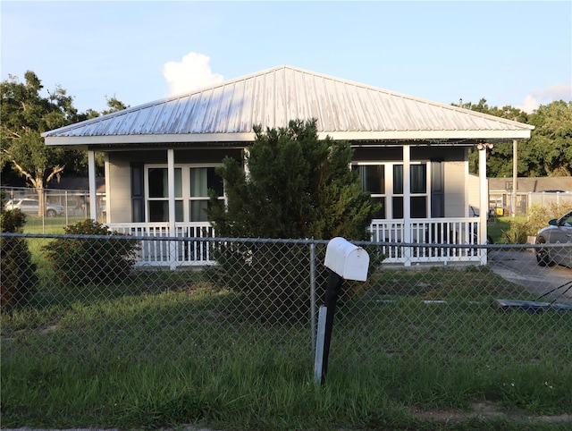 423 Midway Ave, Mascotte, FL 34753 - view of front facade featuring a porch and a metal roof