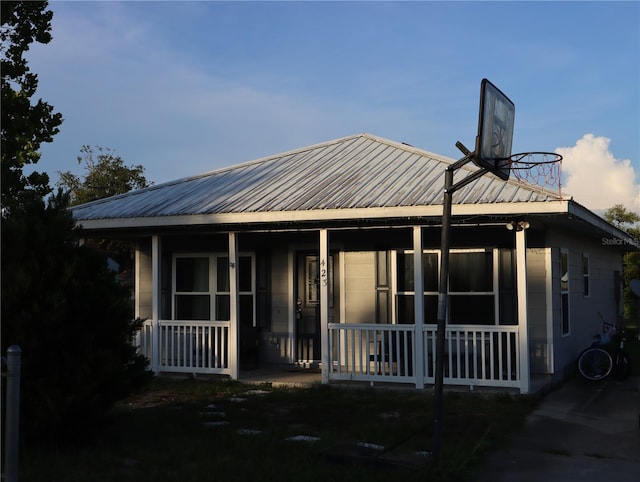 423 Midway Ave, Mascotte, FL 34753 - view of front of property featuring covered porch and a metal roof