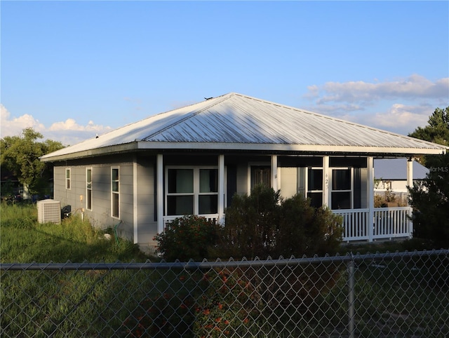 423 Midway Ave, Mascotte, FL 34753 - farmhouse inspired home featuring a metal roof and a porch